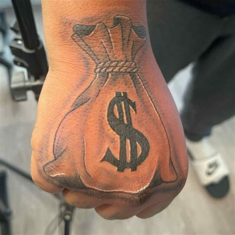 hand money bag tattoo